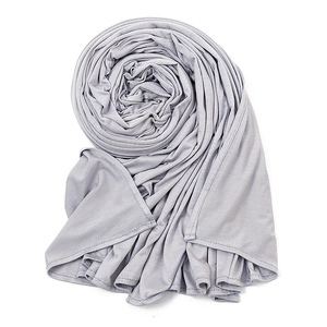 Detail of light grey modal silk cotton scarf showing soft texture and overlock stitched edges