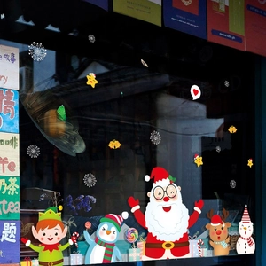 Christmas window decals with Santa, penguin, and Merry Christmas lettering on glass shopfront