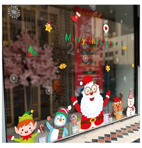 Detail of Christmas window decals featuring Santa, penguins, and snowflakes on glass