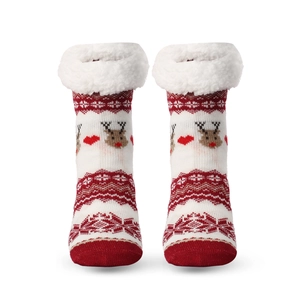 Christmas knit socks with elk pattern and white faux fur trim on a clean white background
