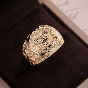 Macro shot of men's vintage gold alloy eagle ring showing intricate embossed patterns