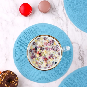 Blue round silicone placemat with wave texture, non-slip heat resistant dining table mat for home kitchen.
