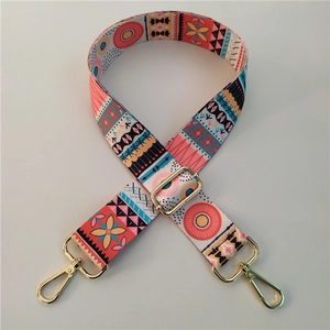 Detail of adjustable bohemian bag strap with colorful geometric patterns and gold metal clips