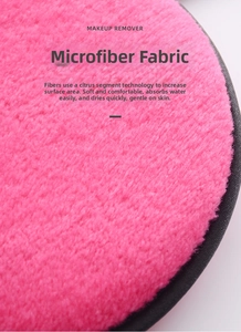 Macro shot of rose red microfiber makeup remover pad with black fabric edging texture