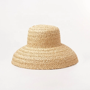 French style raffia straw sun hat with wide brim in a natural beige bell-shaped design