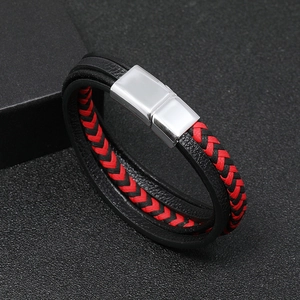 Close-up of multilayer leather bracelet with silver magnetic clasp on black background