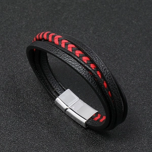 Detail of multi-layer braided leather bracelet with silver magnetic metal clasp