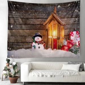 Detail view of a Christmas tapestry with snowman and lantern on wood wall background