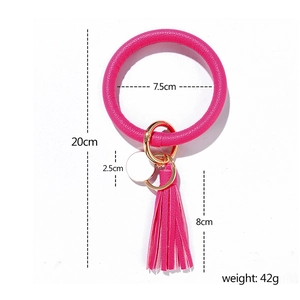 Detail view of hot pink wristlet keychain with dimensions for tassel and round tag