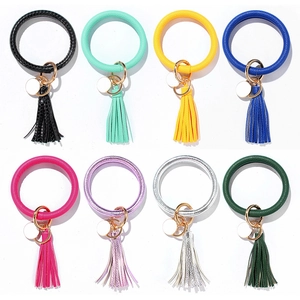 Detail showing various colorful PU leather keychain wristlets with tassels and gold hardware