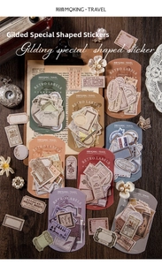 Detail of vintage gold-stamped stationery stickers on retro wooden background