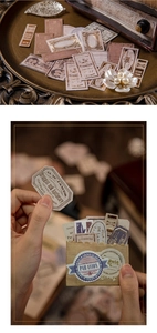Detail of vintage gold-foiled paper stickers featuring antique apothecary labels and motifs