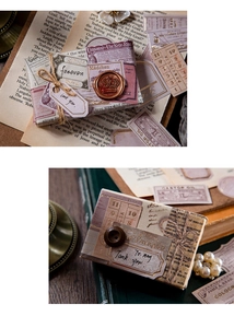 Detail of vintage scrapbooking paper stickers with gold foil accents and wax seals