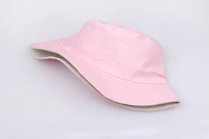Detailed close-up of a pink cotton bucket hat showing soft texture and cream lining