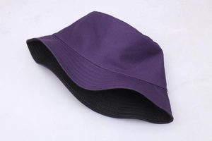 Close-up of a reversible purple and black cotton bucket hat with flat top brim