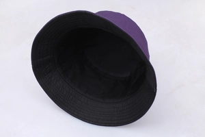 Detail view of the reversible flying aces bucket hat in deep purple and black colors