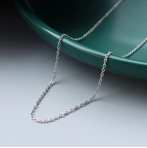 Macro shot of 1.3mm fine stainless steel cross chain with silver metallic luster