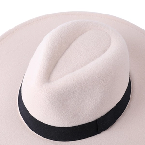 Detailed view of teardrop crown and black ribbon on wool felt fedora hat