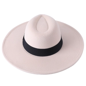 Detail of off-white wide brim felt fedora hat featuring a classic black grosgrain ribbon band
