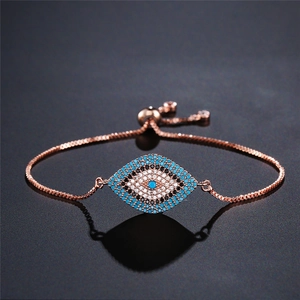 Rose gold evil eye bracelet with micro-p镶 zircon on dark reflective background