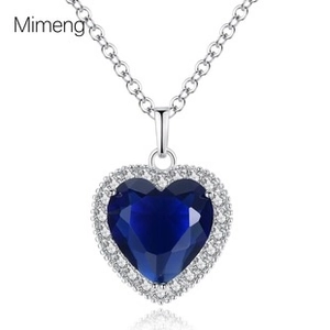 Detail of a heart-shaped necklace with a blue zircon pendant and a silver-tone chain