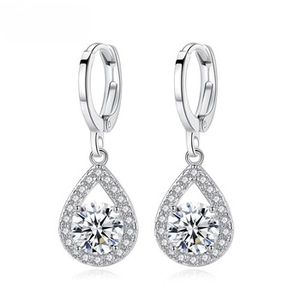 Detail of silver drop earrings featuring pavé settings and a brilliant round main stone