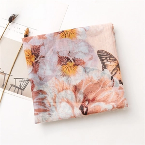 Detail of pink cotton-linen scarf with golden thread butterfly and floral print