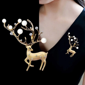 Detailed view and on-model display of gold reindeer brooch with pearls and crystals
