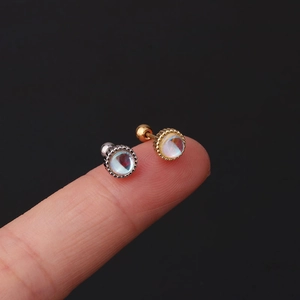 Minimalist stainless steel opal stud earrings in gold and silver held on fingertips