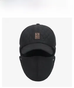 Front view of black quilted winter trapper hat with detachable mask and warm earflaps