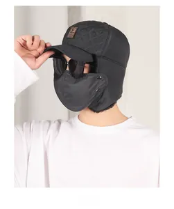Close-up of black winter trapper hat featuring faux fur lining and windproof face mask