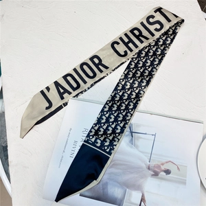 Detail of silk satin twill scarf with classic oblique pattern and contrast lettering