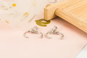 Macro shot of silver plated hoop earrings with pear-cut cubic zirconia pendants