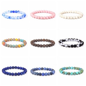Detail view of 8mm natural stone elastic bracelets in nine various colors and patterns
