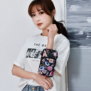 Floral mini crossbody phone bag shown worn on arm for sports and leisure activities