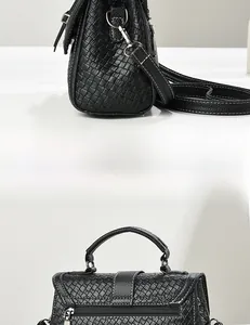 Detail view of woven texture black handbag showing side profile and smooth metal zipper