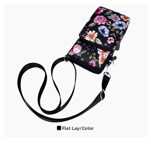 Flat lay of floral phone crossbody bag with double zipper and adjustable strap