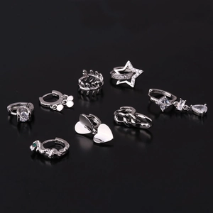 8-piece set of silver geometric earrings featuring heart, star, and snake designs