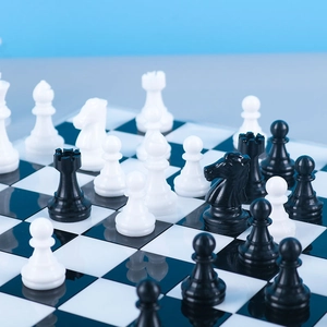 Close-up of gloss finish resin chess pieces on a classic black and white checkered board