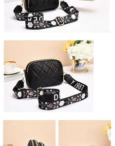 Close-up of black quilted crossbody bag with golden zippers and floral jacquard strap