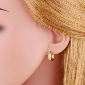 Elegant gold double-row cubic zirconia hoop earrings worn on a model for daily style