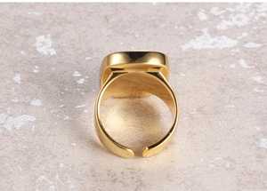 Macro shot of wide gold adjustable ring band with a high-polished finish and open back detail