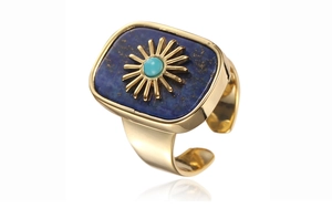 Macro detail of adjustable gold ring with blue lapis lazuli and sunburst metal relief