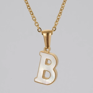 Detailed close-up of golden necklace with white shell inlay letter B pendant