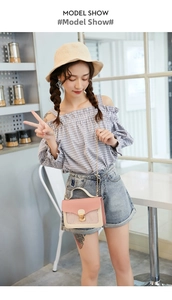 Detail of pink and beige crossbody phone bag with sequin star decor and gold lock