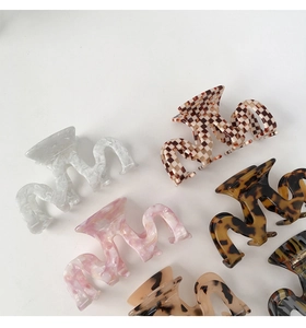 Medium M-shaped hollow acetate hair claws in marble, floral, and checkered patterns