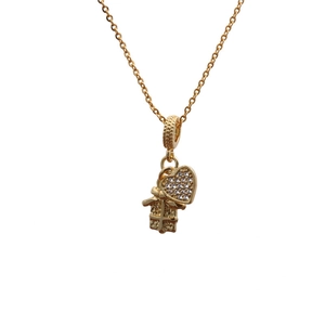 Gold necklace featuring a micro-pave heart and gift box pendant on a white background