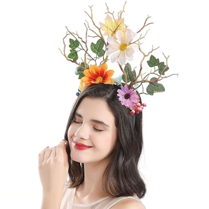 Close-up of a floral headband with red fabric roses, daisies, and green berries