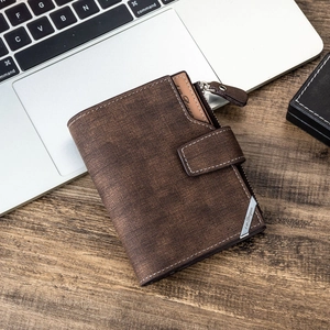 Brown textured leather men's wallet with snap closure and zipper pocket on wooden desk
