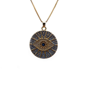 Detail of gold evil eye pendant with blue and white zircons on a delicate box chain